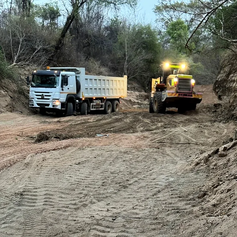 Tipper truck and wheel loader clearing an earthworks site