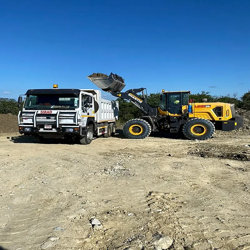 Smad wheel loader loading a white tipper truck on an earthworks site